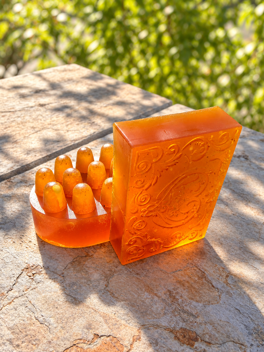 Original Sea Honey with turmeric — amber embossed bar and massage bar on a stone ledge