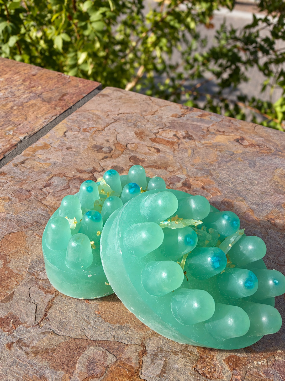 Two blue copper peptide alternate handmade soap bars on a stone ledge