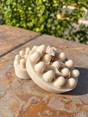 Two cacao goats milk handmade soap bars on a stone ledge