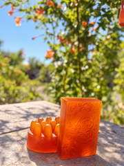 Original Sea Honey with turmeric — amber embossed bar and massage bar on a stone ledge